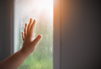 Hand child with fogged on the window.