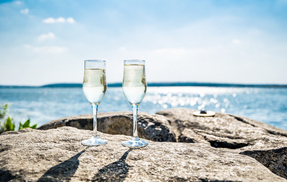 Glasses of champagne against the background of the sunny sea landscape