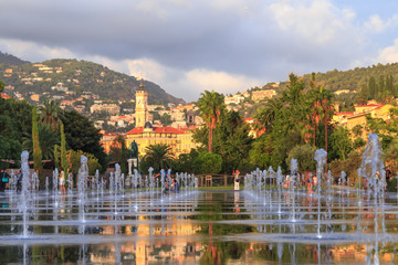 Nice, Cote d'Azur. Fountains on Massena place. View to the old city and mountains from Massena...