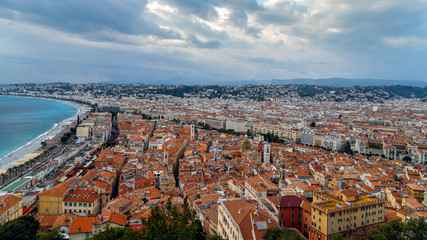 Nice old town, French Riviera, France. View of the city with red roofs, colorful houses and narrow streets, Promenade des Angles and azure sea from above. Travel Europe.