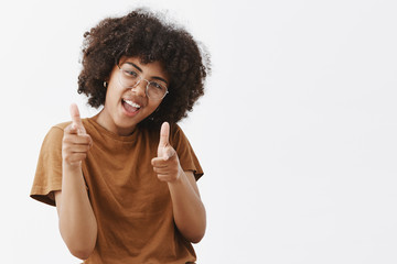 Bang bang you killed. Cool and carefree playful dark-skinned female student in transparent glasses...
