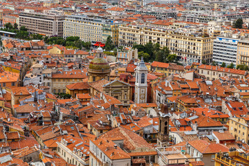 Fototapeta na wymiar Nice old town, French Riviera, France. View of the city with red roofs, colorful houses and narrow streets from above. Travel Europe.