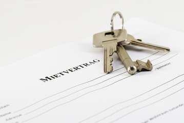 German lease agreement document with house keys,  Mietvertrag means rental contract,copy space
