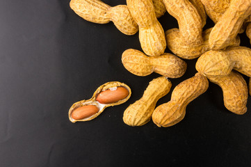 Peanuts in shell on dark background, close up