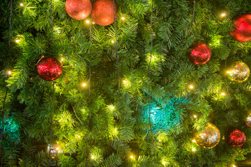 Christmas tree ornaments with colored balls background for festive design season.