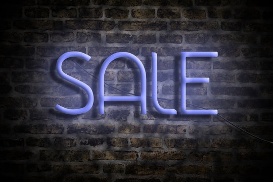Neon inscription Sale on the background of a brick wall. The concept of a business sale.