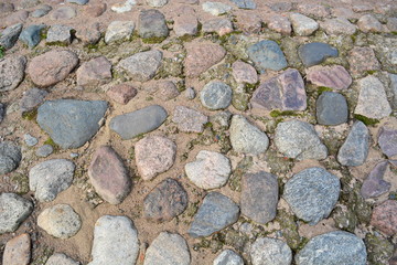 The site of the old ancient road of cobblestone. Texture. Background