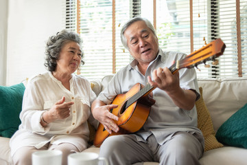 Older Couple enjoying with singing and guitar.