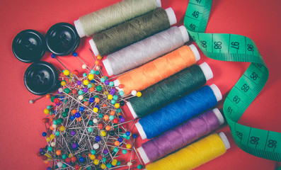 Fototapeta premium Supplies and accessories for sewing - threads, pins, buttons, centimeter.