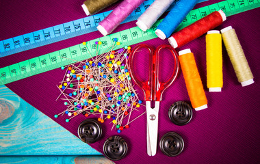 Supplies and accessories for sewing - scissors, threads, pins, buttons, centimeter.