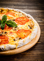 Pizza with ham, tomatoes and mushrooms 