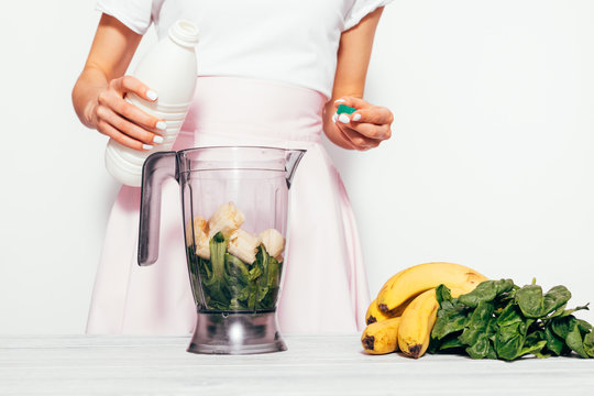 Young Woman Making Healthy Green Smoothie