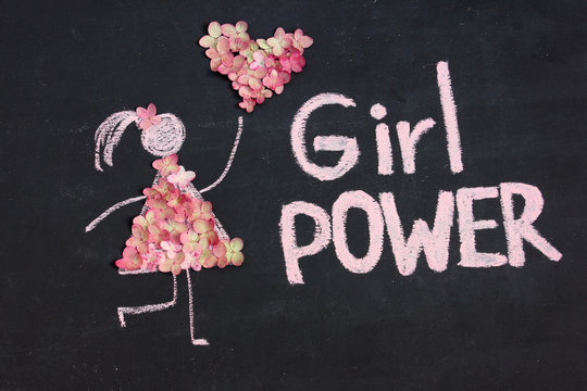 Chalk drawing woman icon dressed in nature flowers with heart from flowers. GIRL POWER inscription on chalkboard or blackboard. Lettering text sign. Women's day, feminism or love concept
