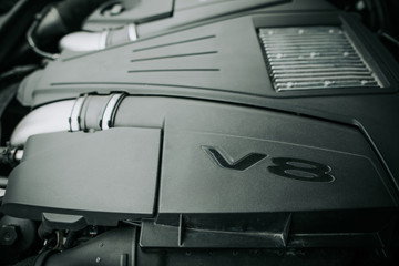 Emblem V8 on black contemporary engine. Modern digital device for car concept