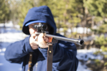 hunter aiming with weapon at the outdoor hunting