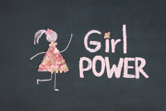 Chalk drawing icon of woman in dress from pink live flowers. GIRL POWER inscription on chalkboard or blackboard. Lettering text sign. Women's day, feminism concept