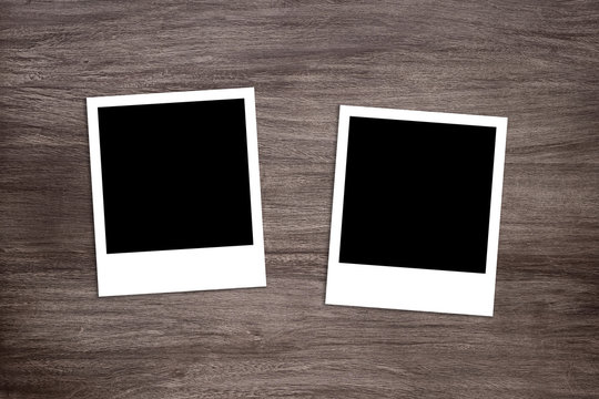 two blackened instant photo print templates on rustic wooden background