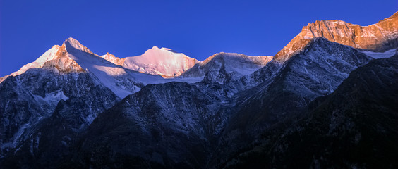 Mountains surrounding Grachen on a clear autumn morning during sunrise (Valais, Switzerland). The village is situated at an altitude of 1,620 meters on a terrace above St. Niklaus in the Mattertal