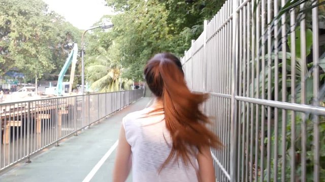 Young asian woman running at park. People with healthcare, sport and exercise concept.