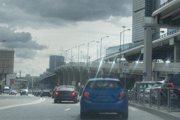 New Riga highway. Elevated roads on cloudy day. City traffic with a lot of cars.