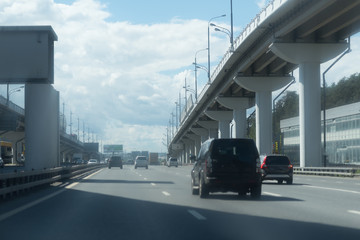 New Riga highway. Elevated roads on cloudy day. City traffic with a lot of cars.