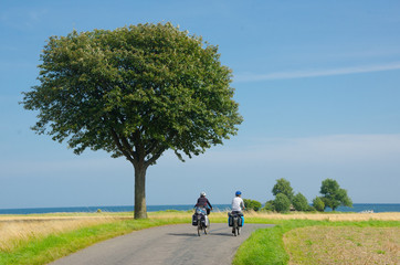 Groupp of  cycle tourist on the scenic countryside road in Denmark - island Mon.
