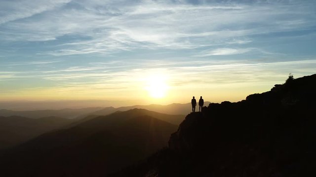The couple on the mountain watching to the beautiful landscape