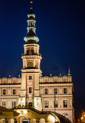 Fototapeta na wymiar Town Hall, an old medieval building in the city of Zamosc in night. Idea for poster, postcard
