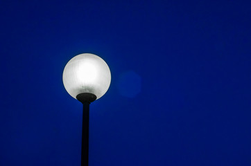 Street lamp on the pillar, shines at night