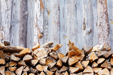 Stacks of firewood in the sawmill. Pile of firewood. Firewood background