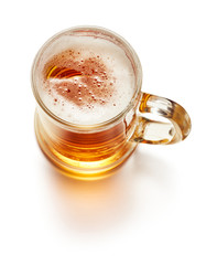 top view of mug of fresh lager beer isolated on white background