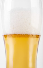 A glass of light beer on a white background. Alcoholic beverages