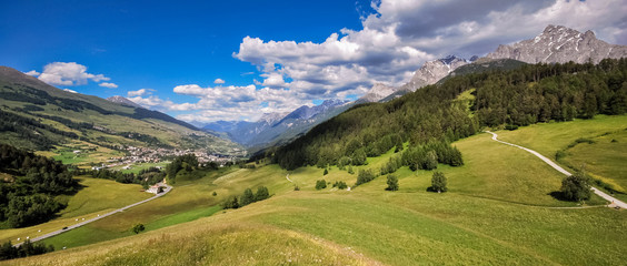 Mountains surrounding Tarasp, a village in the canton of Graubunden, Switzerland. It is situated within the Lower Engadin valley along the Inn River, at the foot of the Sesvenna Range.
