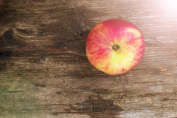 Red apple with water drops on old grunge background
