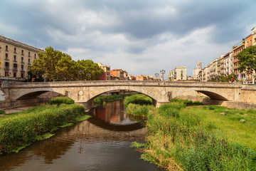 old bridge in Girona on the background of a stormy sky
