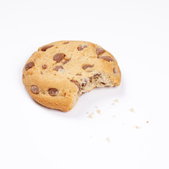  chocolate chip cookie bitten into with crumbs on white                           