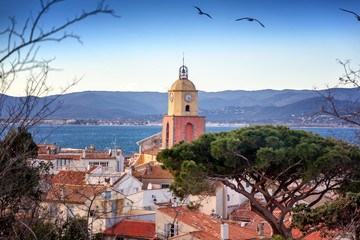 Fototapeta premium View of the old town with tiled roofs and the Gulf of Saint Tropez, beautiful scenery, a trip to the French Riviera in Provence in France