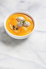 
    Pumpkin soup with meat balls and pumpkin seeds topping. Copy space