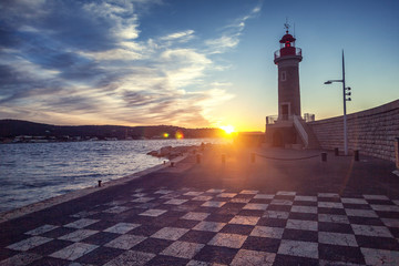 Ancient lighthouse at sunset in Saint-Tropez, a trip to the French Riviera Provence in France © olezzo