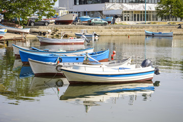 Fototapeta na wymiar Fishing boats in the nessebar harbor, Bulgaria. nessebar marina, boats with reflexions.