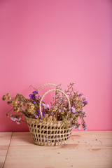 Pink background with dry flower basket for magazine or brochure.