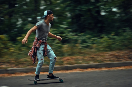 Young people skateboarding on road.