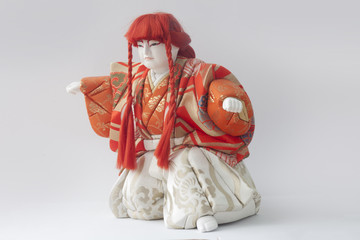 Clay doll of japan of Hakata-ningyoo in red uniform.