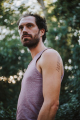 Portrait of man with Kambo ceremony burning marks on his arm