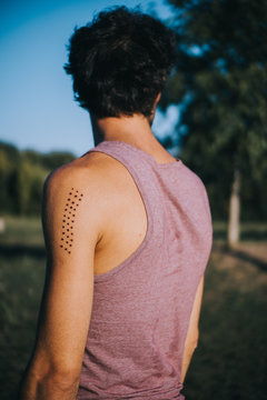 rear view of man with Kambo ceremony burning marks on his arm