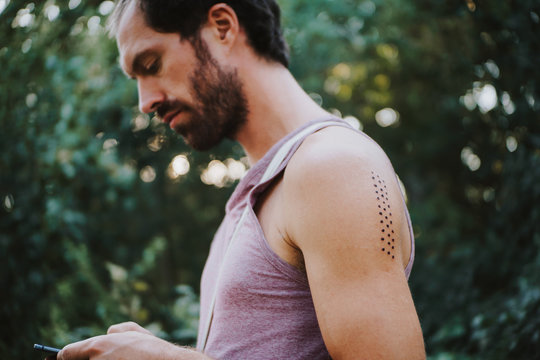 Portrait of man with Kambo ceremony burning marks on his arm