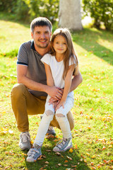 Fototapeta premium Portrait of a young father with his daughter