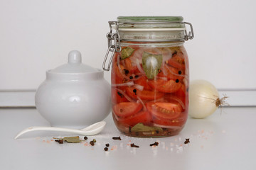 Glass jar of pickled tomatoes