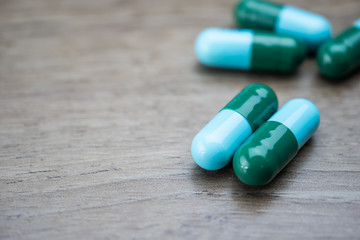 Fototapeta na wymiar drug capsule antibiotic on wood table background
