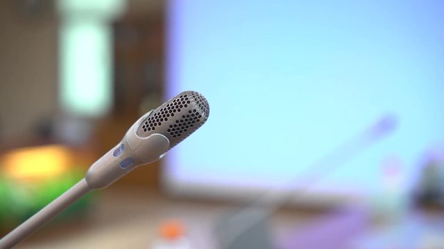Mini Microphone on abstract blurred conference hall for speaker on stage in seminar room background, Business meeting and education in teaching classroom concept. 4k